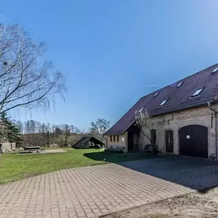 Bild zeigt ein Gebäude und einen gepflasterten Hof davor